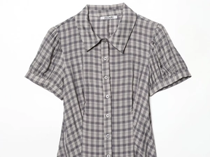 Detail view of plaid short sleeve shirt with turn-down collar and button front closure