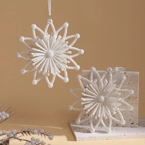 Champagne glitter snowflake and star Christmas ornaments on elegant travertine stones