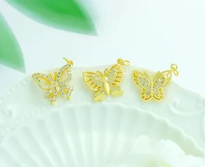 Detailed view of three 18K gold plated butterfly pendants with pavé cubic zirconia