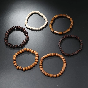Detail view of six handmade wooden beaded bracelets in various shapes and natural tones