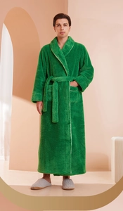 Detailed close-up of thick green plush bathrobe with white trim and waist tie design