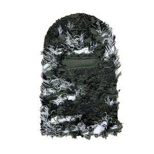 Detail of army green camouflage knitted balaclava with distressed tassel textures