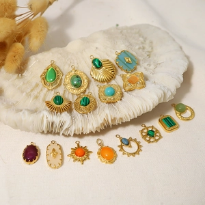 Assorted bohemian natural stone pendants in various shapes on a white coral base