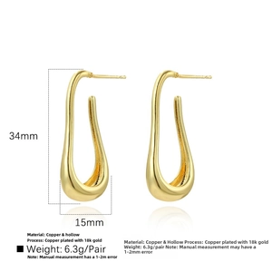 Detailed view of hollow U-shaped earrings in 18k gold plated copper with 34mm length