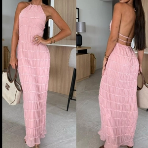 Macro shot of pink pleated texture and criss-cross back ties on backless maxi dress