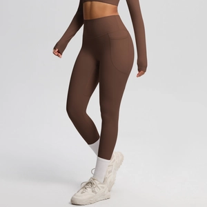 Detail view of high waist coffee yoga pants featuring a practical side pocket for phone