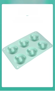 Close-up of smooth mint green silicone donut mold highlighting its non-stick interior