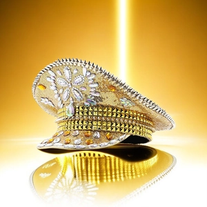 Close-up of golden captain hat featuring sequins, silver spikes and intricate rhinestones