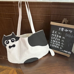 Close-up of a cartoon cat canvas tote bag with 3D ears and embroidery details