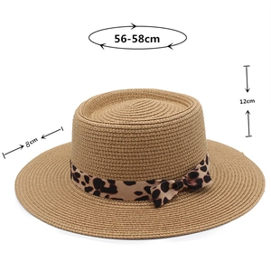 Detail shot of flat top straw hat showing dimensions 56-58cm with leopard ribbon