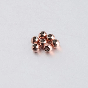 Macro shot of 5mm rose gold stainless steel round beads with 2mm holes for DIY jewelry