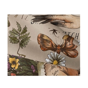 Detail of vintage fabric tapestry showing moth, floral prints and woven texture