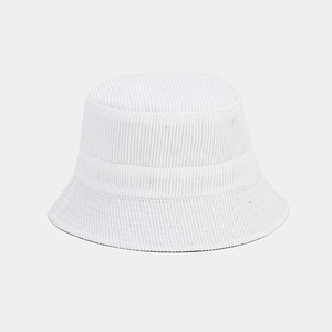 Detailed texture of white corduroy fabric on a minimalist reversible bucket hat