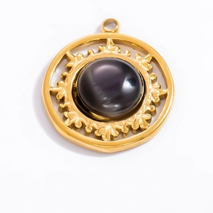 Macro shot of 18k gold plated stainless steel pendant with round black obsidian stone