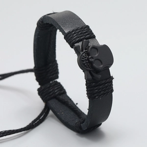 Men's fashion black braided leather bracelet featuring a cool skull and crossbones charm