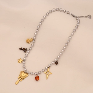 Detail of gold bear and melting heart charms on a silver beaded stainless steel chain