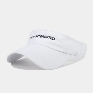 Detailed close-up of white sun visor with black NOT INTERESTED embroidery text