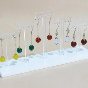 Five-tier acrylic T-bar stand displaying assorted colorful bead dangle earrings