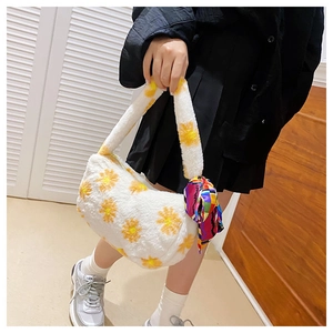 Detail of white fluffy handbag featuring yellow daisy patterns and a colorful silk scarf