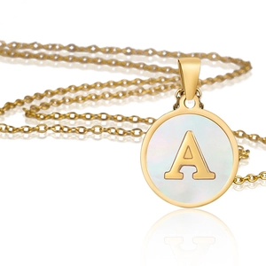 Detailed view of a gold stainless steel round necklace with white inlay and letter A
