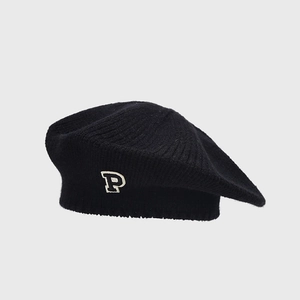 Close-up of black knitted beret featuring white embroidered P letter and wool texture