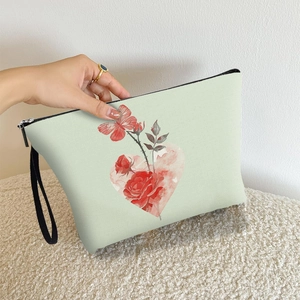 Green canvas makeup bag with vintage rose floral prints and a convenient wrist strap