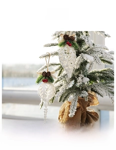 White hollow Christmas ornament with pine cones and red berries on a rustic hemp rope