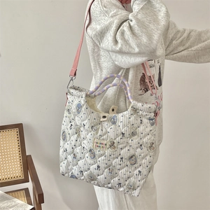 Quilted blue striped tote bag with cartoon bear print and pink shoulder strap detail