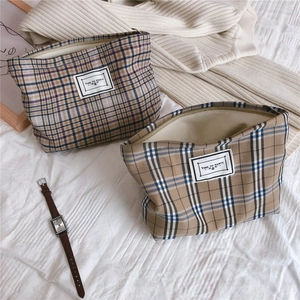 Detail of vintage plaid canvas makeup bags with zipper and TIME TO PARTY label