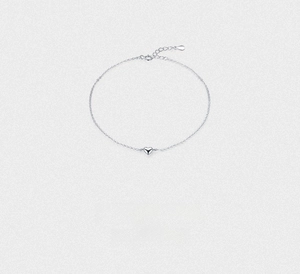 Close-up of a minimalist silver heart pendant with a delicate fine chain necklace