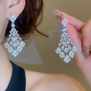 Detail view of luxurious silver tassel earrings with sparkling pear-cut zircon crystals