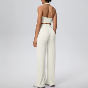 Back view of a halter neck sports top and high-waist wide-leg pants in soft cream white