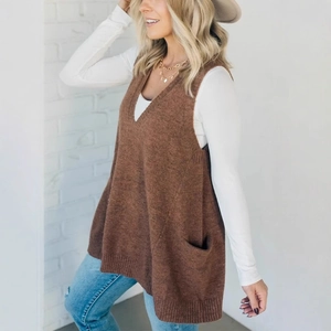 Women's brown V-neck knitted vest with pockets paired with white long sleeve top