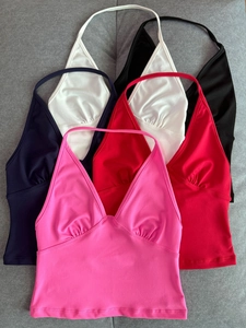 Detail showing colorful halter neck knit crop tops in pink, red, navy, white, and black
