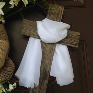 Easter wooden cross wreath with white lilies, burlap bow, and chiffon scarf on door
