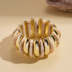 Close-up of bohemian acrylic marble resin and gold metal elastic cuff bracelet