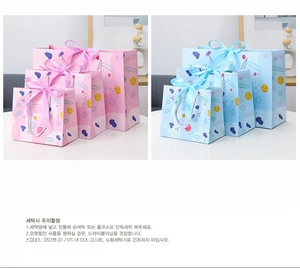 Pink and blue paper gift bags in three sizes with starry planet patterns and ribbon handles