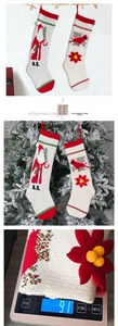 Detail of knitted Christmas stockings with Santa and bird patterns on a white background