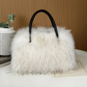 Close-up of fluffy white faux fur tote bag with black leather handles on wooden background