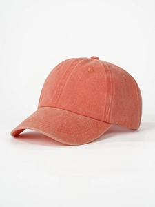 Detail of coral orange washed cotton baseball cap with vintage texture and stitched eyelets
