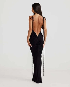 Detailed back view of a slim fit black maxi dress with ruched details and open back design