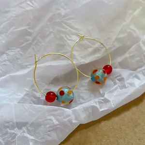 Chic gold-tone hoop earrings with red and light blue polka dot resin beads for women