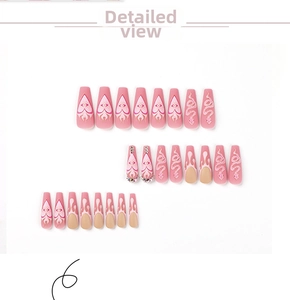 Detailed view of pink matte press-on nails featuring 3D snake design and rhinestone accents