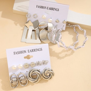 Detailed view of silver alloy earring set with faux pearls on fashion display card