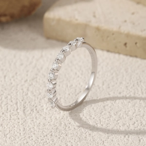Elegant S925 sterling silver eternity ring with moissanite diamonds on stone surface