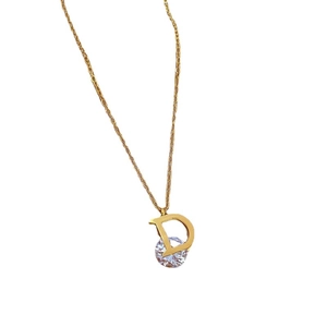 Gold titanium steel D-letter necklace with sparkling zircon pendant on white background