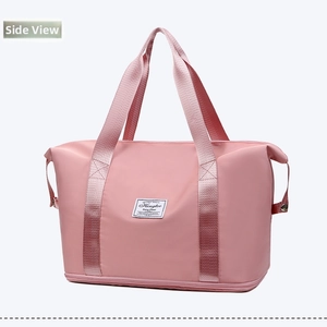 Detailed side view of light pink waterproof travel bag with double handles and bottom compartment