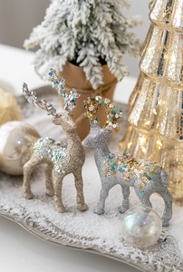 Detail of elegant champagne and silver glitter reindeer figurines for Christmas decor