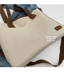Close-up of canvas tote bag showing brown shoulder strap and Banaba leather logo patch