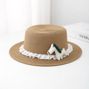 Close-up of brown straw flat top hat with white lace trim and cute stuffed puppy detail